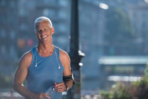 portrait of handsome senior jogging man while relaxing  and take break after morning run